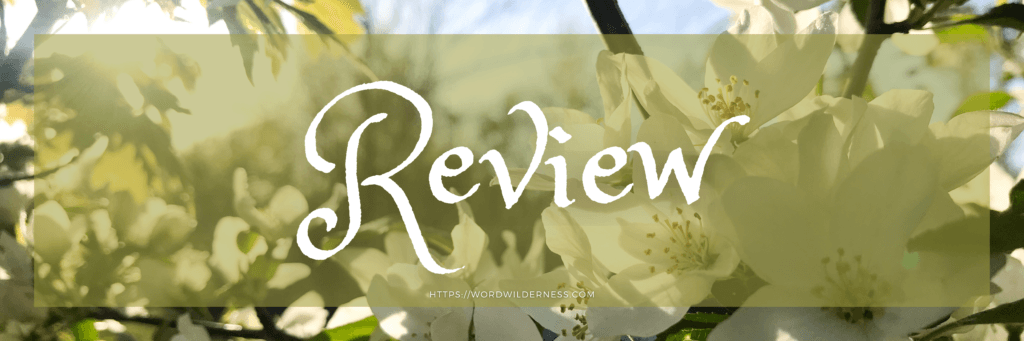 Header image that says Review in white text. A tree branch with white flowers and sunlight shining through is in the background.